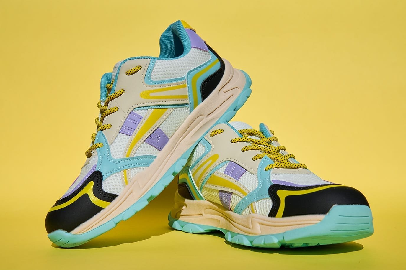 Fashionable Sneakers on yellow background. Creative banner with stylish shoes