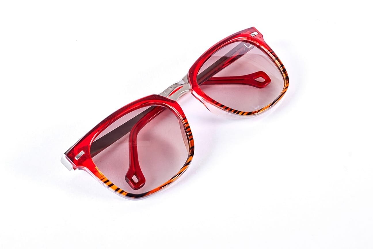 Red sunglasses isolated on white background.